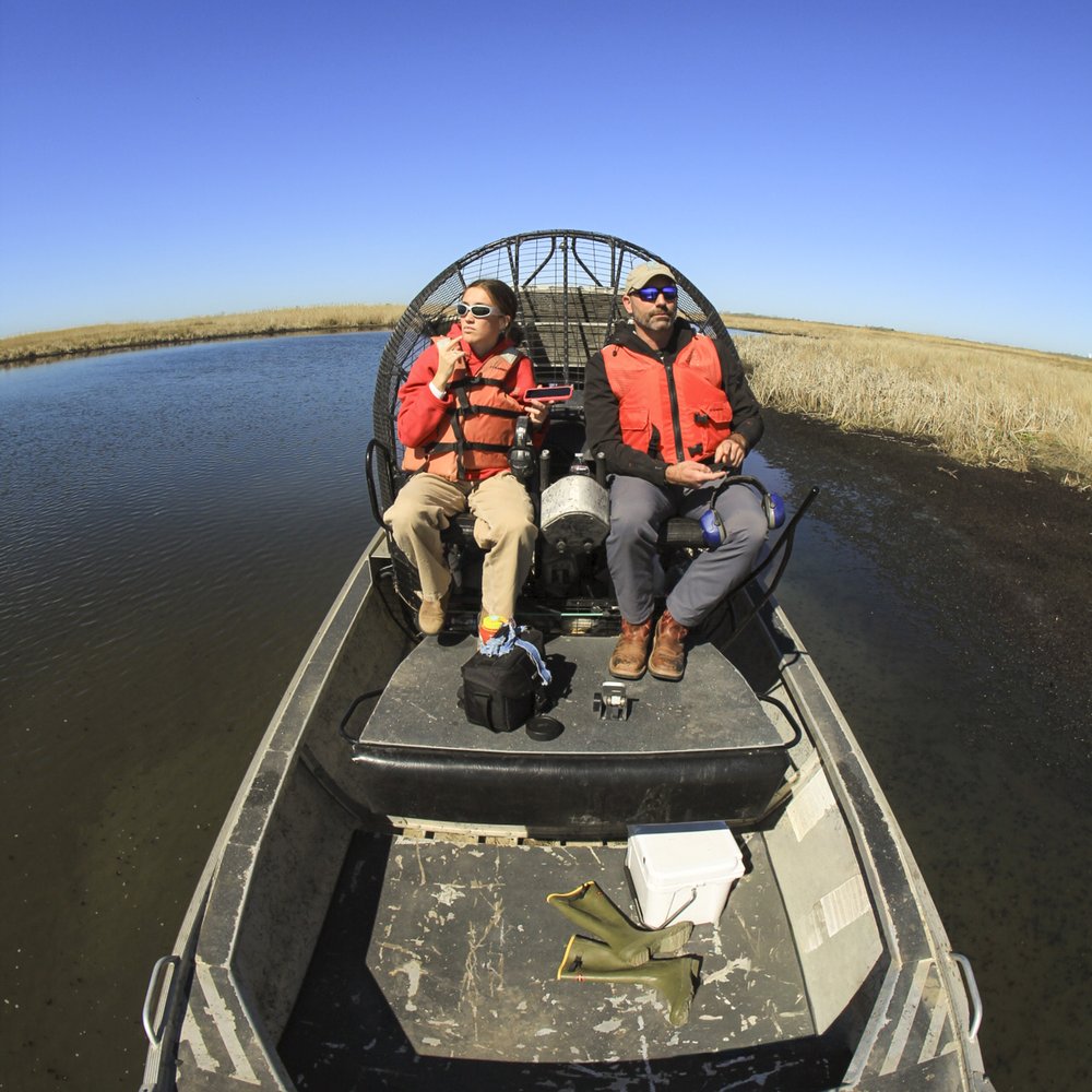 Two people on an airboat.