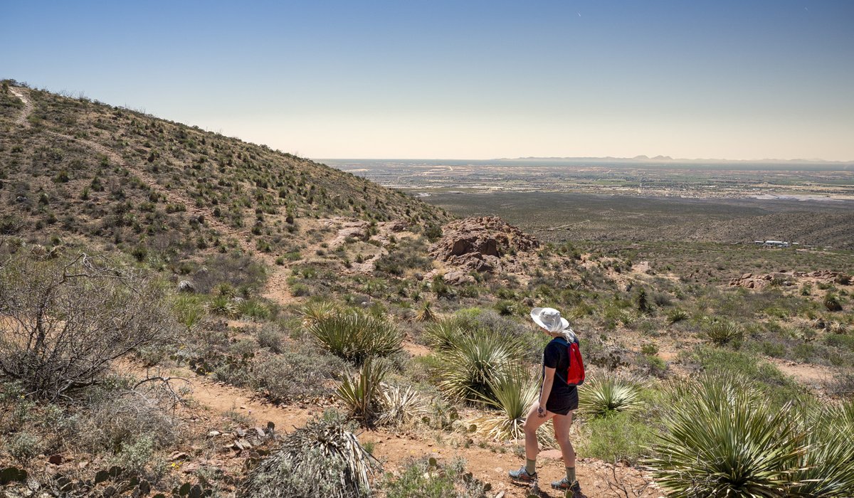 A person hiking through hills.