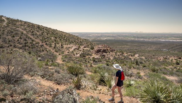 A person hiking through hills.