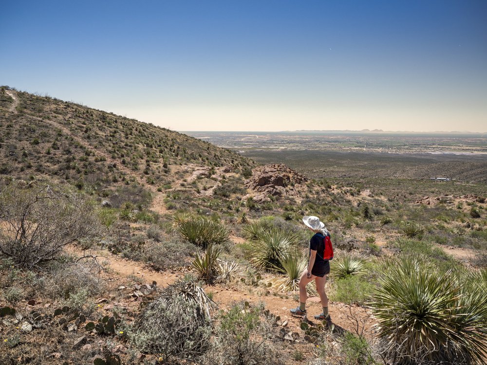 A person hiking through hills.