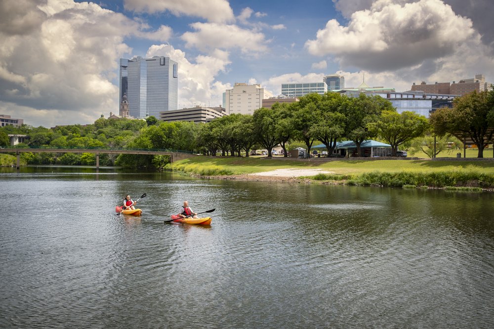 Two kayaker on a lake near the city,