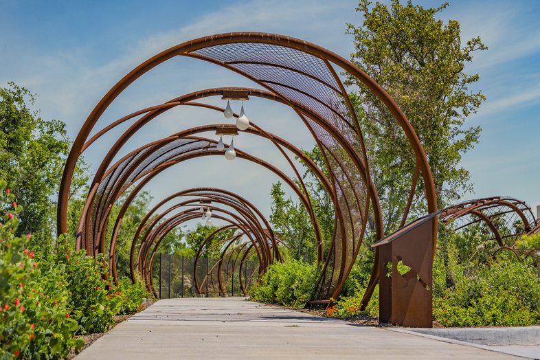 Circle arches on a trail creating a tunnel through the trees.