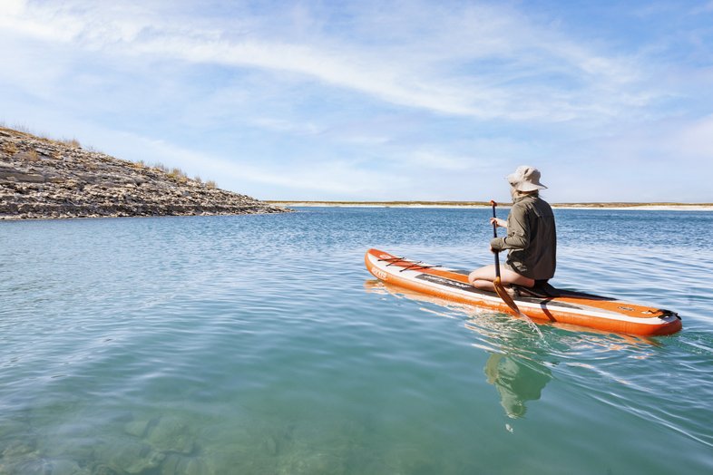 A person in a Kayak in a lake.