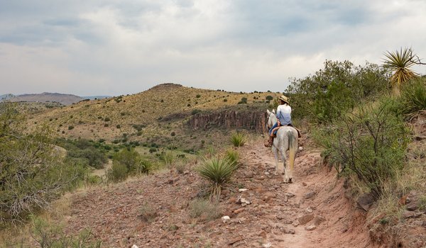 Author Shannon King rides her horse along the Limpia Creek trail at Davis Mountains