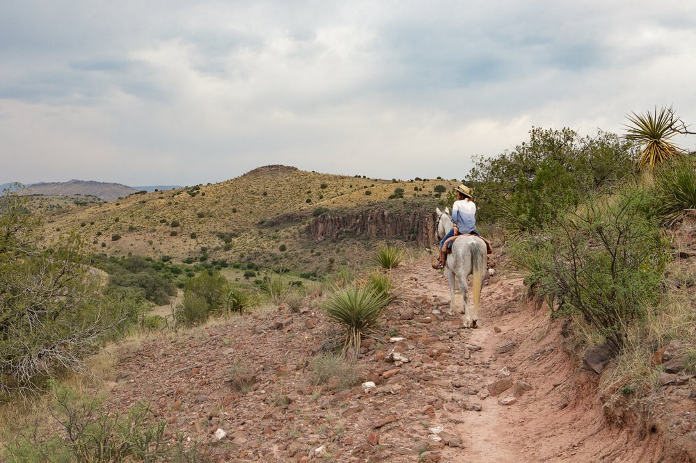 Author Shannon King rides her horse along the Limpia Creek trail at Davis Mountains