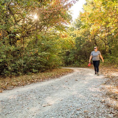 A hiker walks the Bluebird trail at Ray Roberts Lake state park