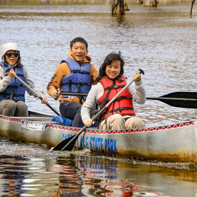 The Huang family paddles to shore