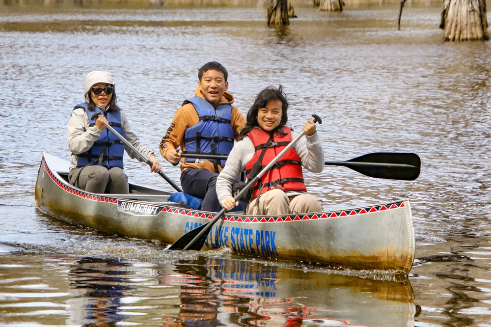 The Huang family paddles to shore