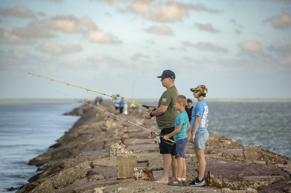 A family fishing on a fishing jetty at Isla Blanca Parka