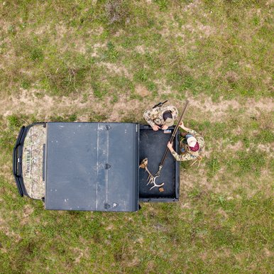 Deer hunters gather materials out of their ATV in preparation for the hunt