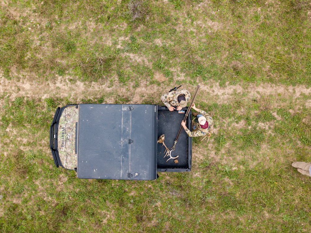 Deer hunters gather materials out of their ATV in preparation for the hunt