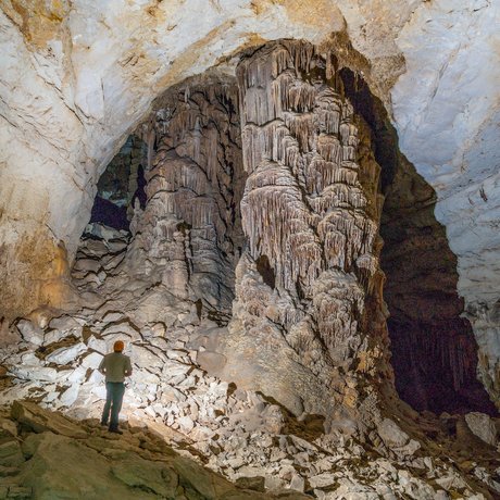 An explorer looks up from inside Kickapoo Cavern