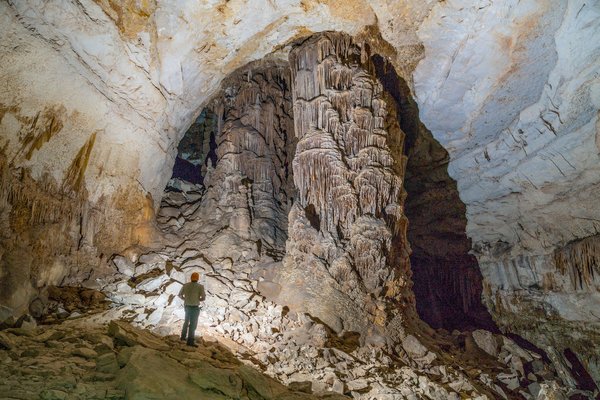 An explorer looks up from inside Kickapoo Cavern