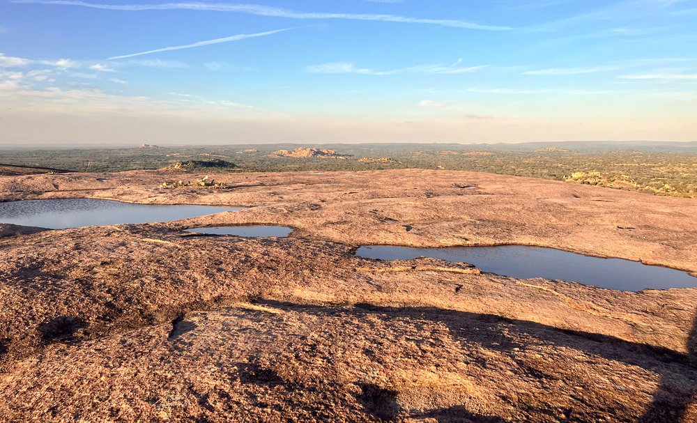 Vernal pool filled with rainwater at Enchanted Rock