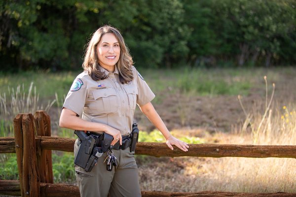 Joann Garza-Mayberry stands alongside a fence