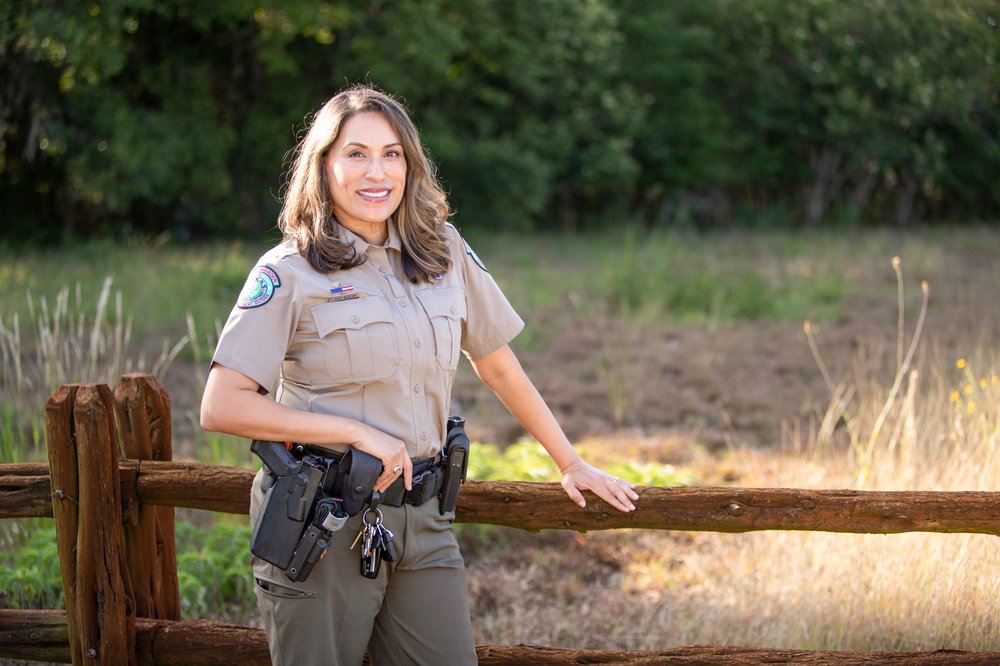 Joann Garza-Mayberry stands alongside a fence
