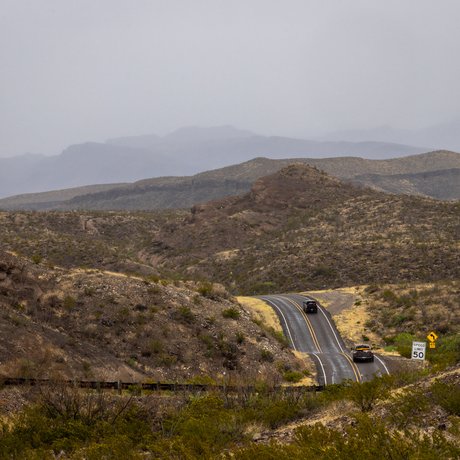 The winding ribbon of River Road follows the bends of the Rio Grande