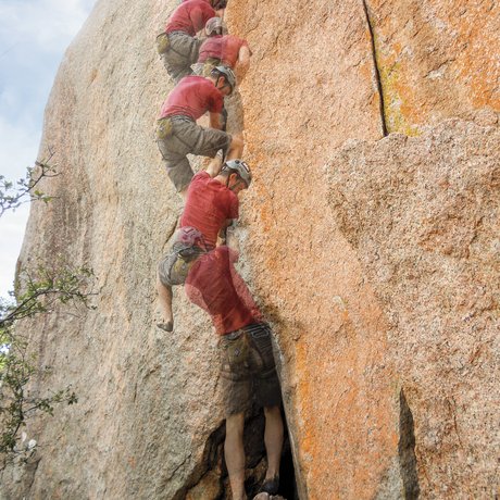 A multi-stage photograph showing the ascent of a climber working his way up a large rock face
