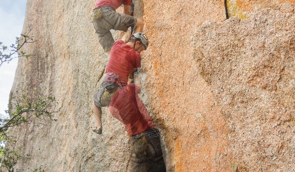 A multi-stage photograph showing the ascent of a climber working his way up a large rock face