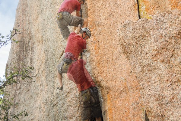 A multi-stage photograph showing the ascent of a climber working his way up a large rock face