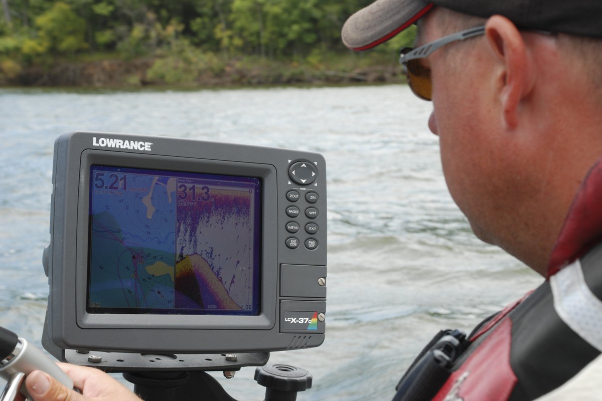 An angler checks the readings on his boat's fish finder screen