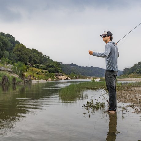 Americana singer/songwriter Calder Allen prepares to cast his fly rod along the river