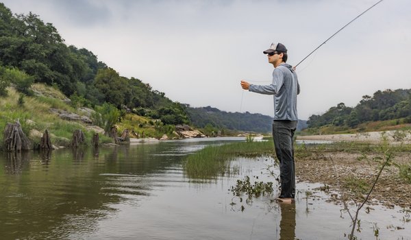 Americana singer/songwriter Calder Allen prepares to cast his fly rod along the river
