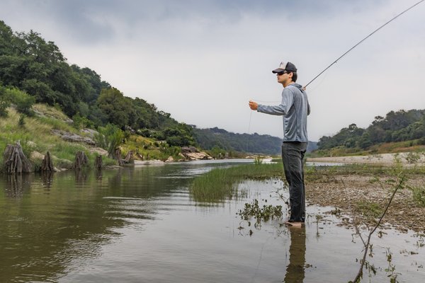 Americana singer/songwriter Calder Allen prepares to cast his fly rod along the river