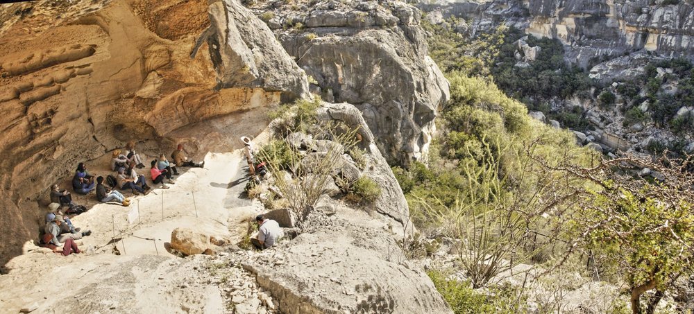 Wide shot showing the rock shelter where White Shaman pictographs are located