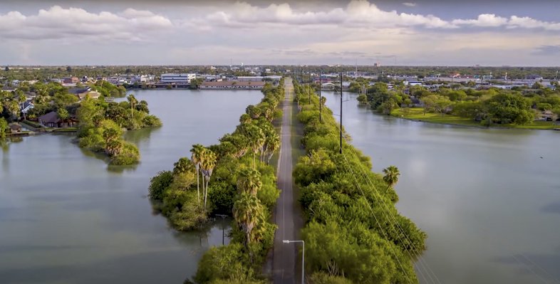 Aerial shot of Caracara Trail in Rio Grande Valley surrounded by resacas with water.