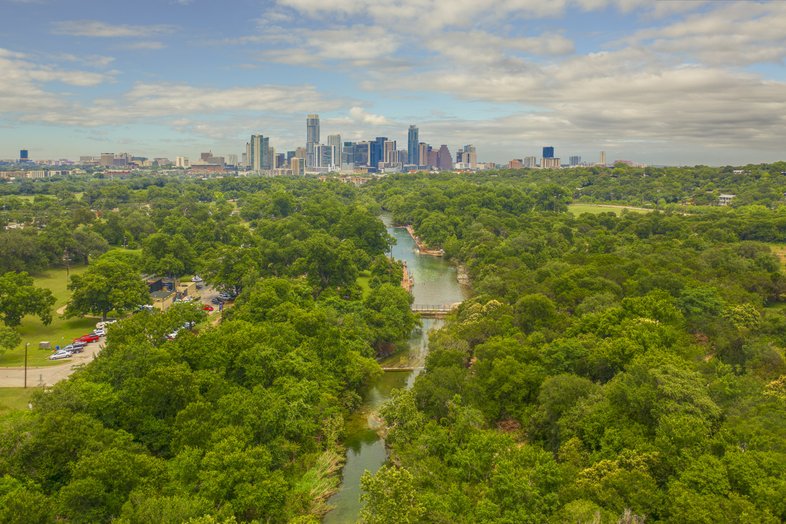 Aerial image of Barton Springs with Austin skyline in background