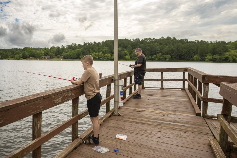 Father and son fishing on pier off Tyler Lake in state park