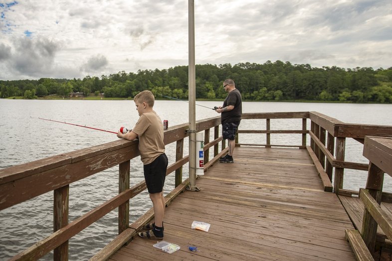 Father and son fishing on pier off Tyler Lake in state park