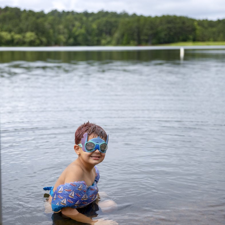 Young boy with swim floats in lake at Tyler State Park
