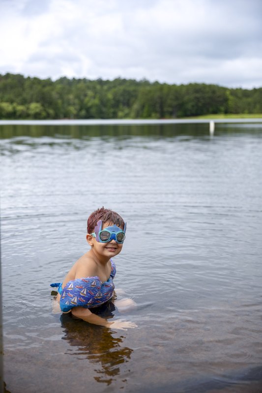 Young boy with swim floats in lake at Tyler State Park