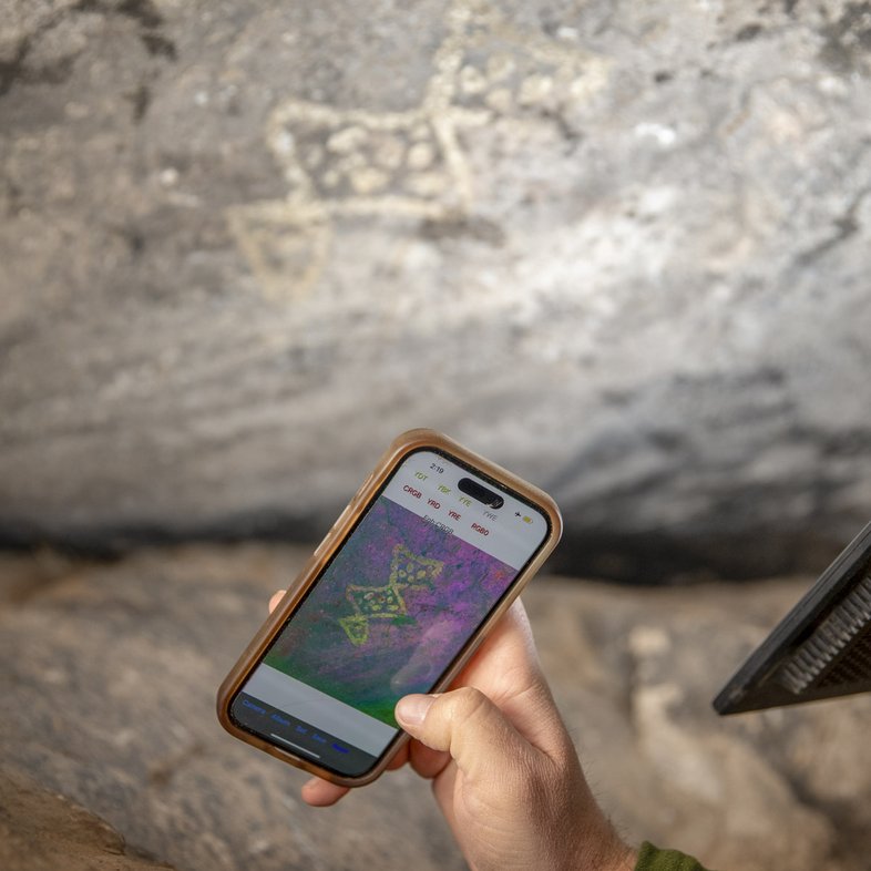 Using a color app on phone to take photo of rock art