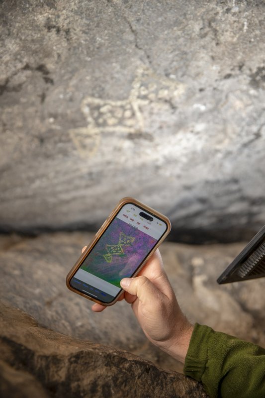 Using a color app on phone to take photo of rock art