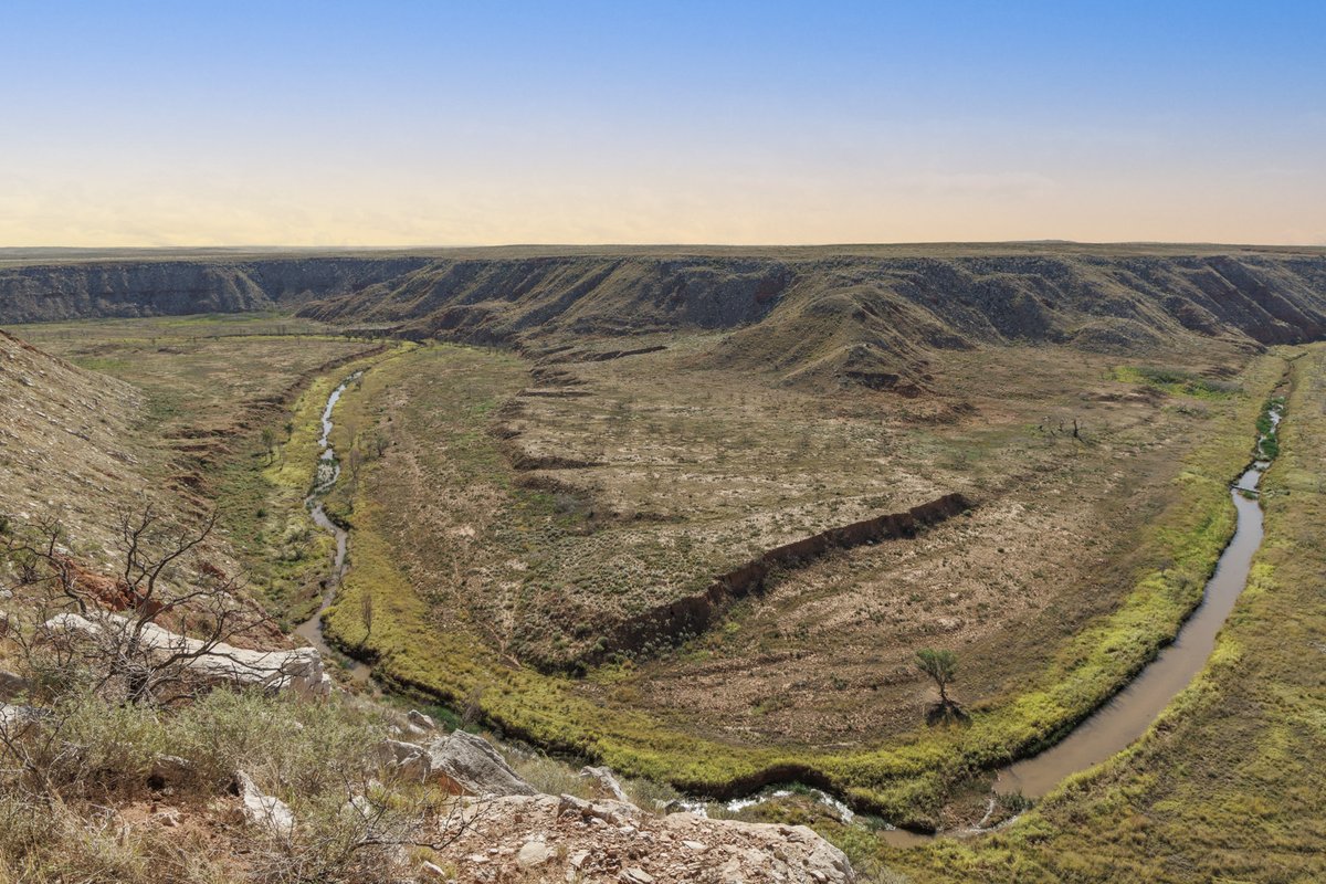 Wide shot of a canyon with winding Canadian River at sunset