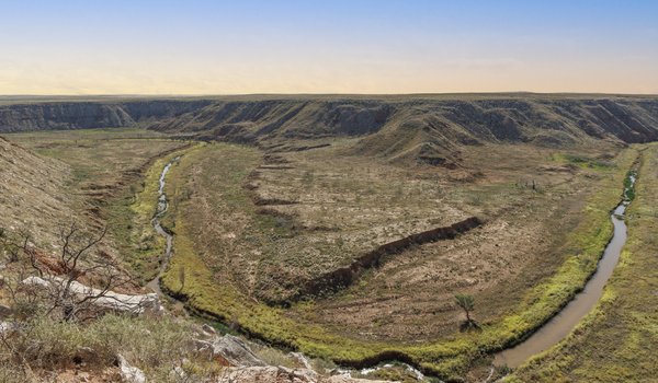 Wide shot of a canyon with winding Canadian River at sunset