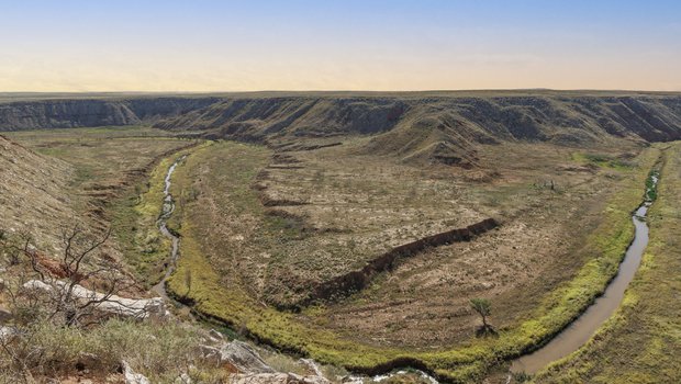 Wide shot of a canyon with winding Canadian River at sunset