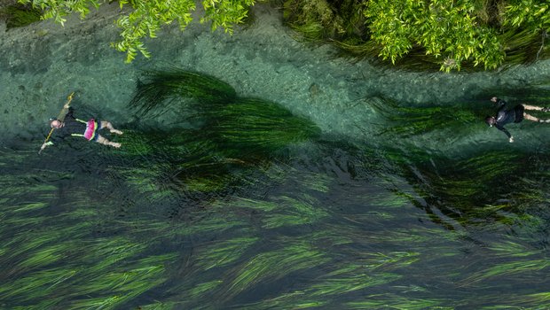 People floating in the San Marcos River for spearfishing.