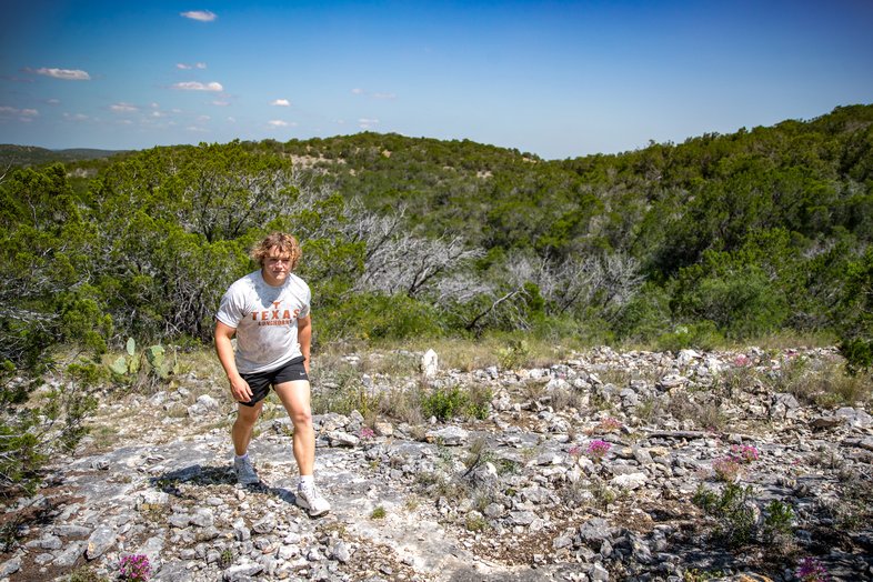 A hiker on Arroyo Camino Trail at Kickapoo Cavern State Park.
