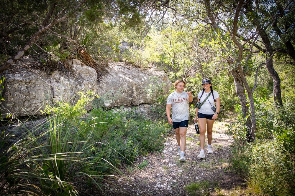 Hikers on Long Way Home Trail at Kickapoo Cavern State Park.
