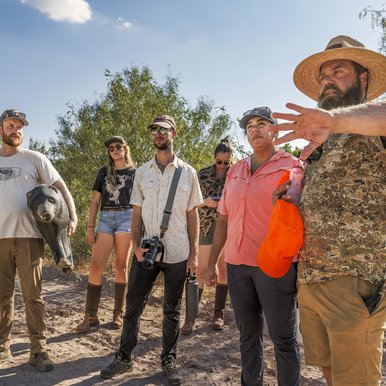 A group of new hunters scouts their location before a hunt
