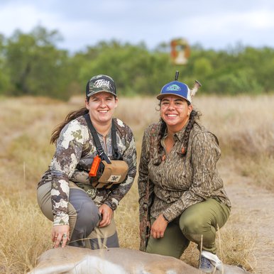 Meagan McElya and Ittzel Rodriguez pose above Rodriguez's first deer