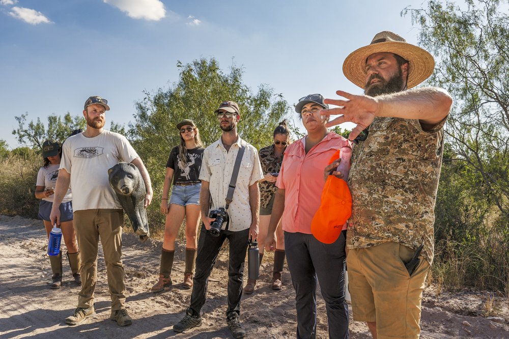 A group of new hunters scouts their location before a hunt