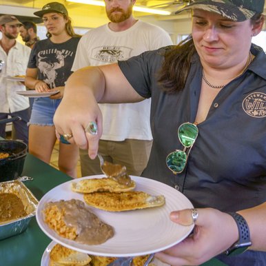 Meagan McElya loads her dinner plate at a mentored hunting event