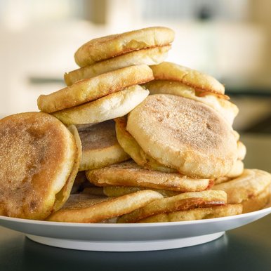 A stack of english muffins on a plate