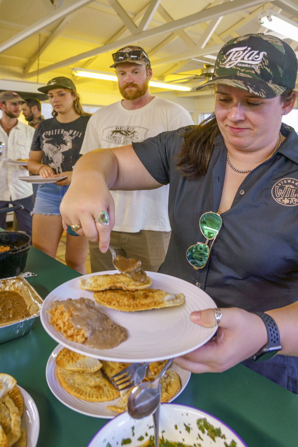 Meagan McElya loads her dinner plate at a mentored hunting event