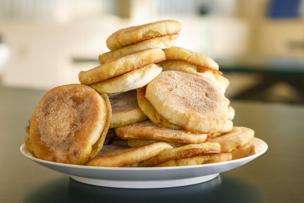 A stack of english muffins on a plate